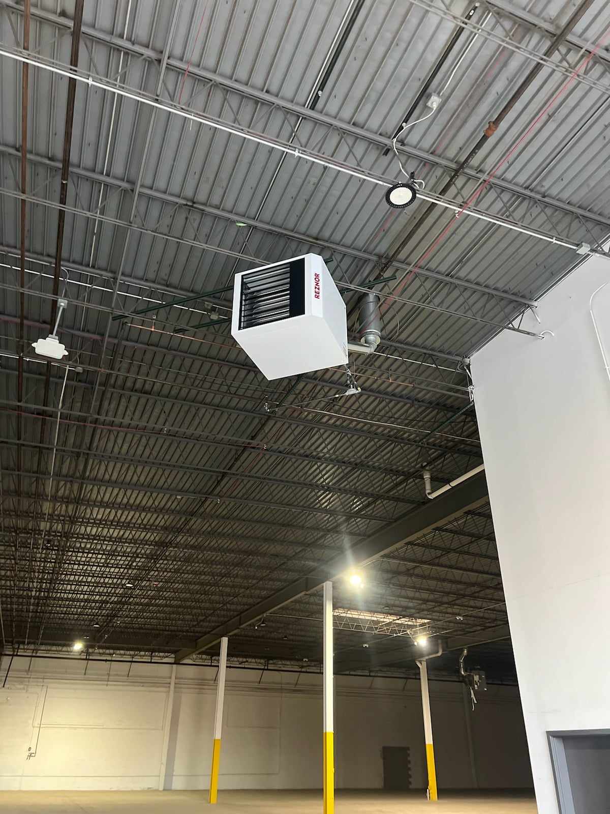 Gas-fired unit heater installed in a warehouse by American Mechanical Works