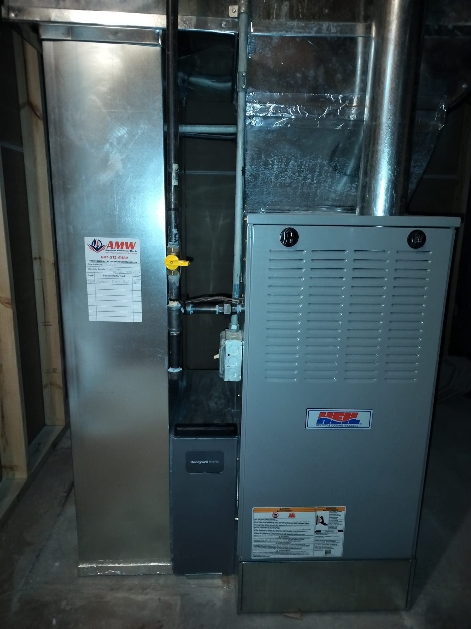 Technician inspecting the burners and flame sensor inside a residential gas furnace